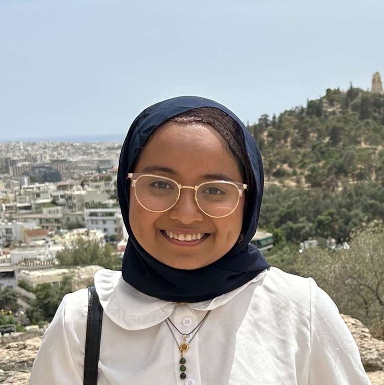 Headshot of Rashida Lan in front of mountain