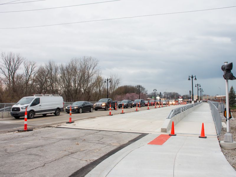 View of Bluffton Road Bridge construction, showing a completed sidewalk and partially finished road 