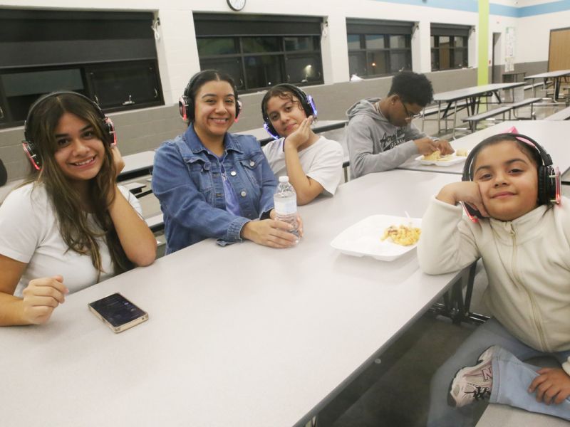 Residents gather to participate in a silent disco for the neighborhood