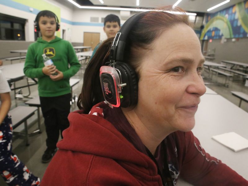 Residents gather to participate in a silent disco for the neighborhood