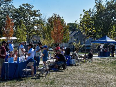 Community members line up to talk with different community groups