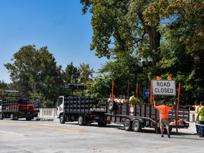 Workers take down the road closed signs at Parnell Ave. Bridge 