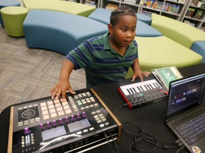 Residents gather to participate in a music workshop for the neighborhood