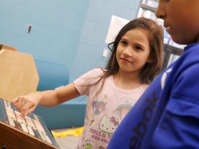 Residents gather to participate in a music workshop for the neighborhood