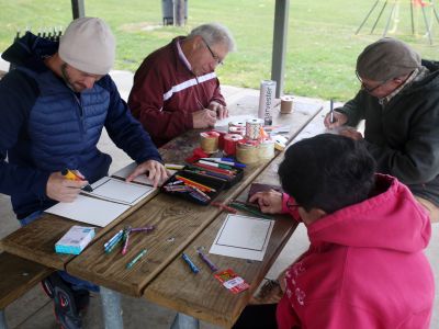 Image of a group of residents gathered around a table for Shout Out Fort Wayne event in the Harvester Neighborhood