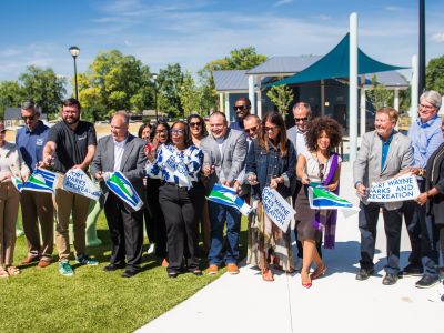 Photo showing city officials and residents cutting the ribbon on the newly opened Brewer Park 